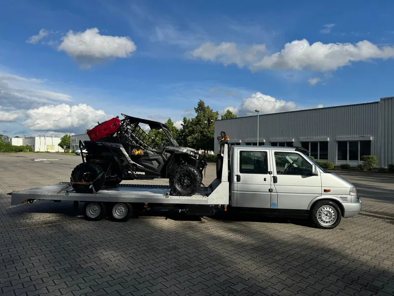 Platforma Tow'n Go cu un UTV Polaris încărcat și fixat cu chingi pe fiecare roată